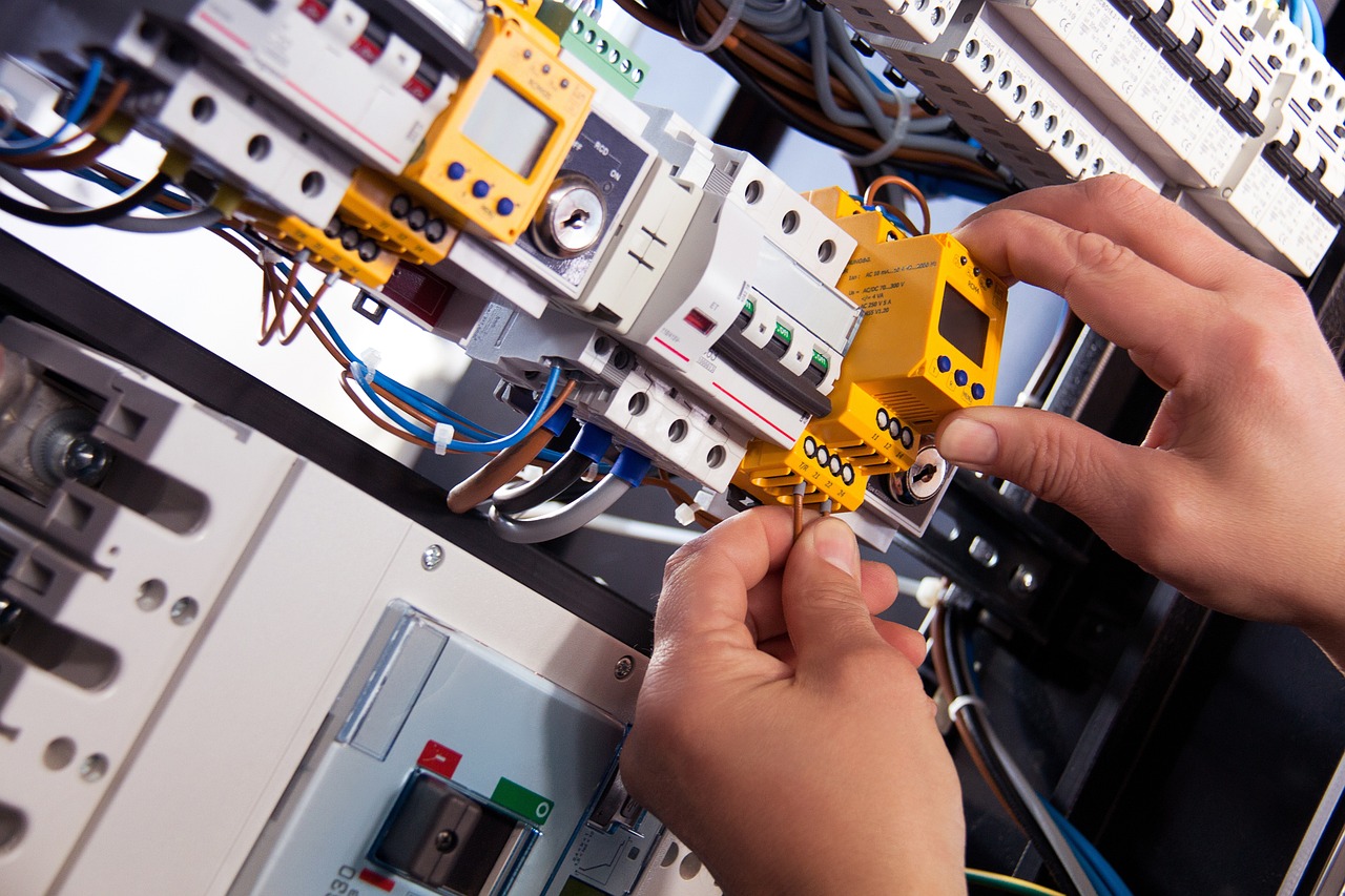 A professional electrician installing and wiring a receptacle box for safe and efficient electrical power.