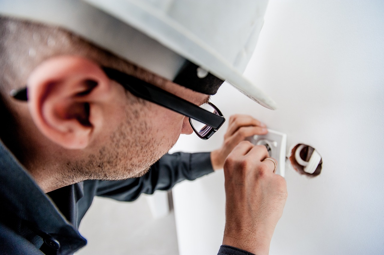 A qualified electrician testing an electrical outlet to ensure safe and proper electrical installation.