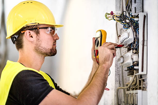 Electrician reviewing a wiring diagram, choosing the right professional for switchboard upgrades to ensure electrical safety.